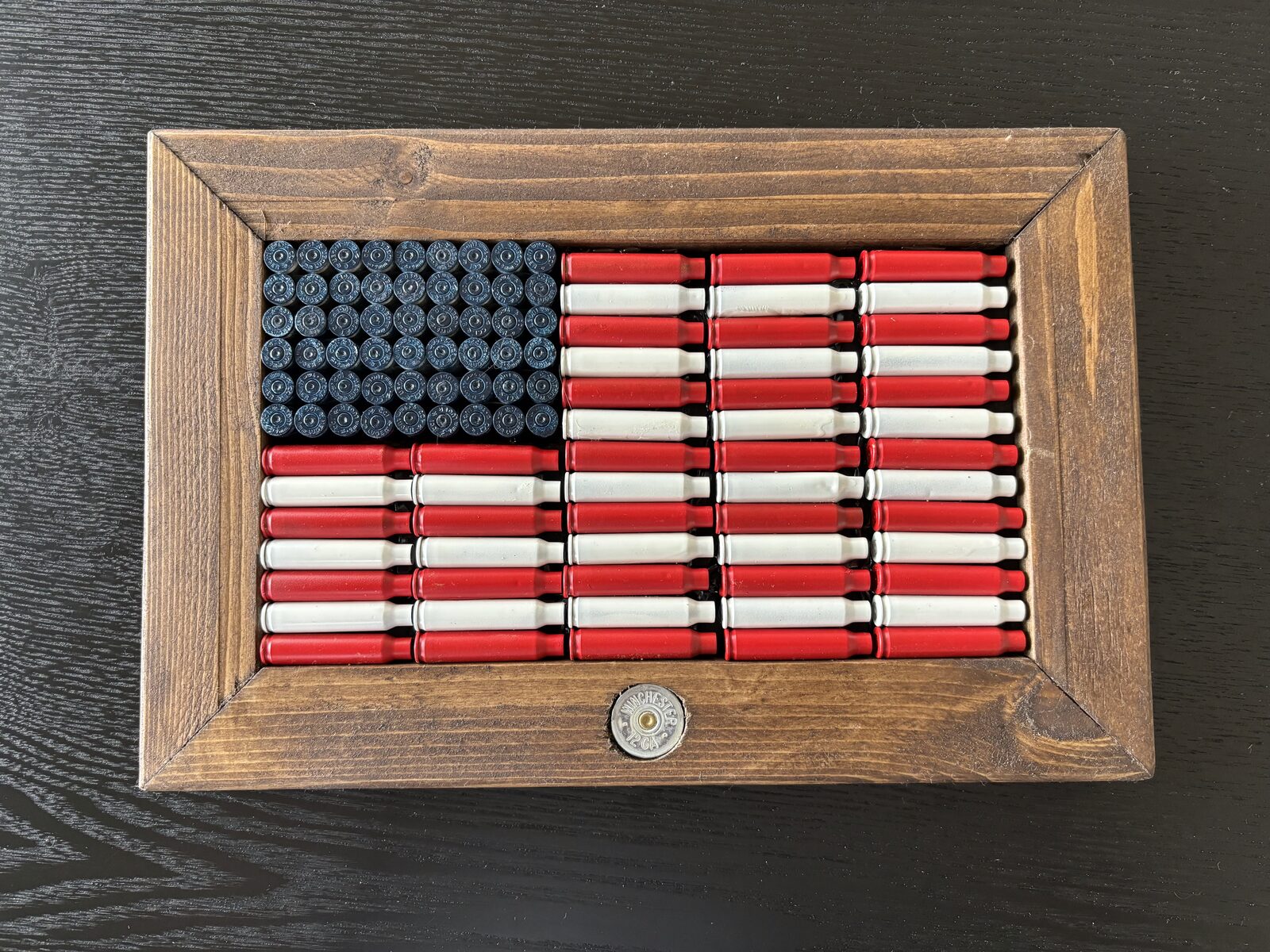 Featured hand-painted red, white and blue brass flag in a rustic frame